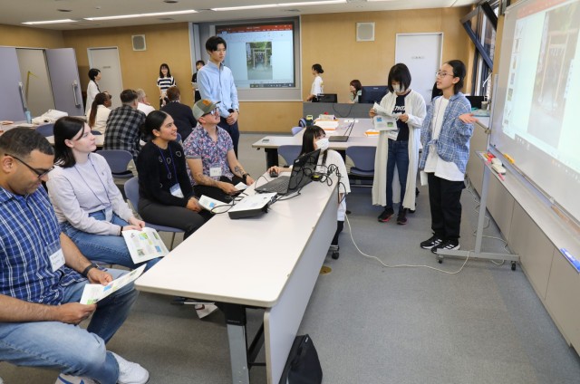 Momoko Yoshida, right, gives a presentation on Zama City to Camp Zama volunteers during a language and cultural event at Zama City Hall, Japan, May 3, 2024. The volunteers helped a group of students get ready for an exchange trip this summer to...