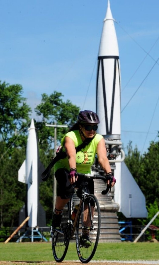 Jamie Miernik rides near Rocket Park on Redstone Arsenal. The cyclist played a large role in bringing the Tour d’ Arsenal to life 20 years ago.