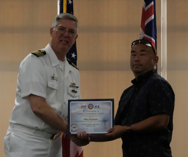 Miles Watanabe, Air Conditioning Equipment Mechanic Leader, U.S. Army Garrison Hawaii (right) accepts the Federal Employee of the Year – Trades and Crafts Excellence Award from Capt. Richard Jones, Commander, PHNSY & IMF at the Honolulu-Pacific...