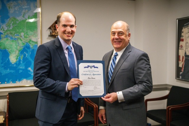 Evan Derrow, the Chief of Operations for U.S. Army Combat Capabilities Development Command, or DEVCOM, Command, Control, Communications, Computers, Cyber, Intelligence, Surveillance and Reconnaissance Center, left, receives a certificate of appreciation from the Honorable Ronald Keohane, the Assistant Secretary of Defense for Manpower and Reserve Affairs, right, during the Department of Defense Talent Management Innovation Challenge April 25, 2024, at the Pentagon, Washington, D.C.