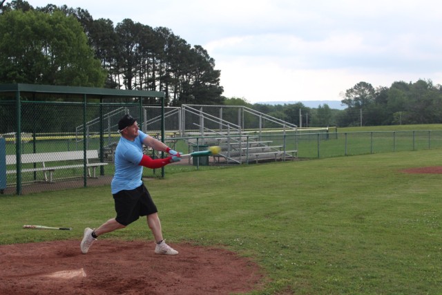 Retired Sgt. 1st Class Chris Tilley makes contact at the plate.
