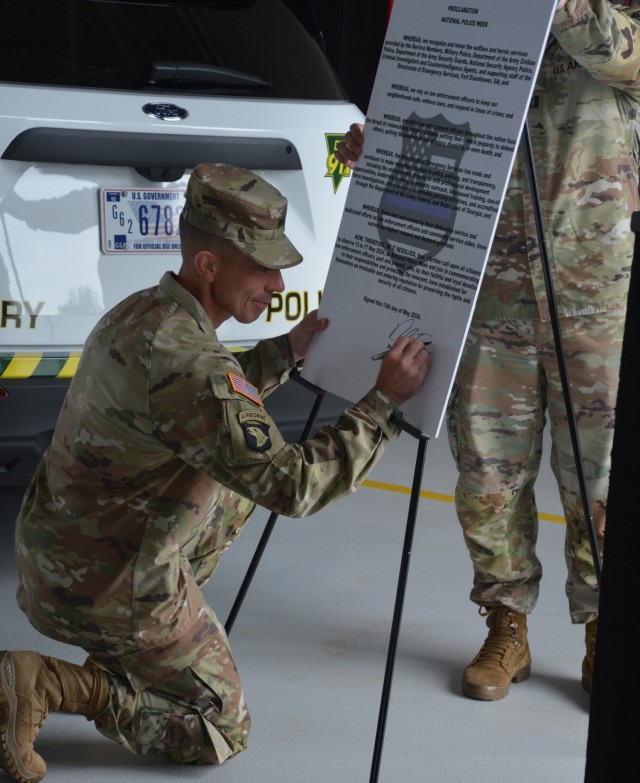Maj. Gen. Paul T. Stanton, commanding general, U.S. Army Cyber Center of Excellence and Fort Eisenhower signs the proclamation for the Fort Eisenhower Garrison Directorate of Emergency Services National Police Week opening ceremony, May 13.