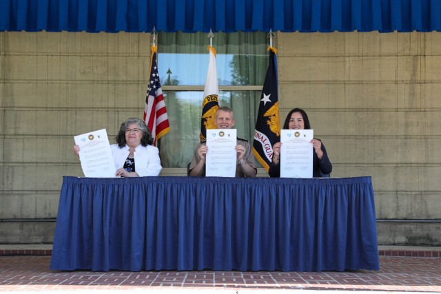 Army Gen. Daniel Hokanson, chief, National Guard Bureau, joins Cara Calvin-McFerren, mayor pro tem, West Liberty, Iowa, and Jessica Chang, chief executive officer, Upwards, to sign a pilot child care intergovernmental support agreement at the...