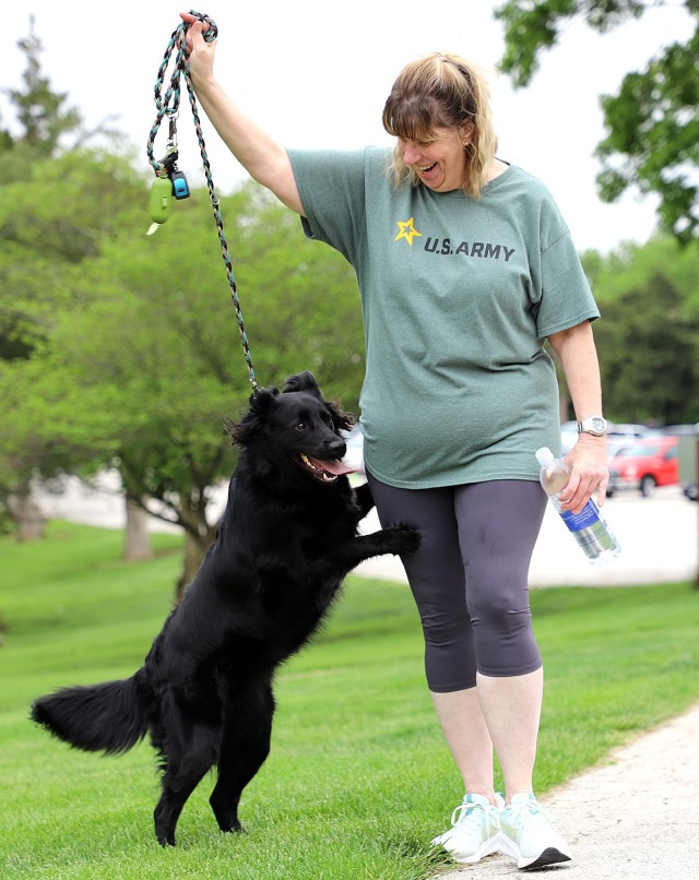 Rebecca Song, Freedom of Information Act liaison at the U.S. Disciplinary Barracks, and her dog Lilly begin the Army Corrections Brigade Wellness Program Volksmarch May 8 from the Frontier Conference Center parking lot leading to the trail around...