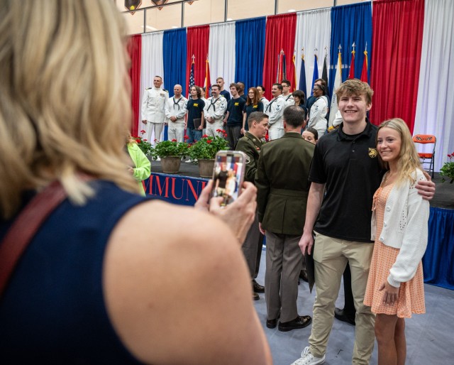 Following the Community Salute to Service event May 10 in the Waynesville High School gymnasium, loved ones pose with students being honored for their decision to join the military.