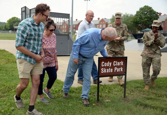 After unveiling the new skate park sign, Cody Clark’s brother Patrick Clark and parents Lori Clark and James Clark move forward to look at the sign, as Directorate of Public Works Chief of Operations Jerry Clark, Garrison Commander Col. Duane...