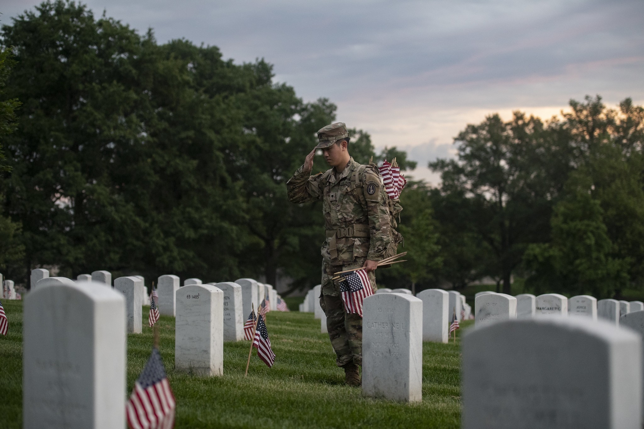 Soldiers from the 3d U.S. Infantry Regiment (The Old Guard) place U.S. flags at gravesites in Arlington National Cemetery, Arlington, Va., May 23, 2024. This was the 76th anniversary of Flags In where over 1,500 service members placed more than...