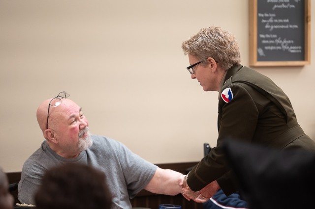 Brig. Gen. Christine Beeler, commander of the Army Contracting Command, greets veteran Bruce Furlong at the Floyd E. “Tut” Fann State Veterans Home’s Memorial Day ceremony Monday.