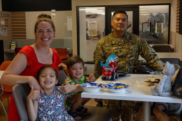 Lt. Col. Seth T. Varayon, Sr., (right) poses with his family (from the left) his wife Julie, daughter Calliope and his son Seth, Jr., while his daughter Willa sits to the side of the table out of the