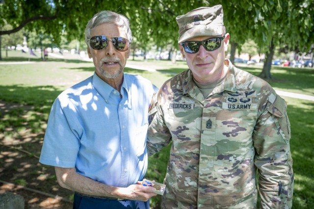 U.S. Army Command Sgt. Maj. Arthur Fredericks, the Connecticut National Guard&#39;s senior enlisted advisor, presents Rick Maynard a Connecticut World War I Campaign Medal in honor of his great-uncle&#39;s service with the 102nd Infantry Regiment...