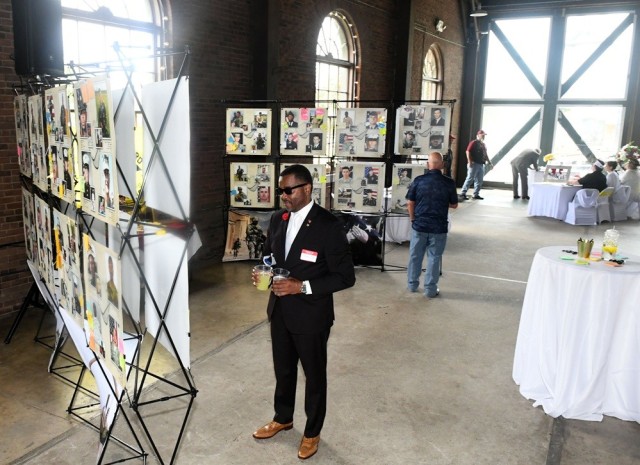 Guests view the exhibit during the second annual Celebration of Life for Gold Star families Monday at the Roundhouse in Huntsville.