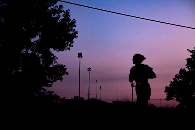 A Cadet runs in the dawn light for the Army Combat Fitness Test at Fort Knox, Ky., on June 13. Once Cadets finish their run on the track, they can finally rest, the ACFT being completed.