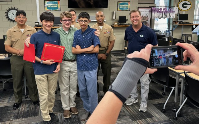 (front row, left to right) Liam Fedak, Jacob Mills and their friend, Leo Garcia, son of Gunnery Sgt. Damian Arredondo. (back row, left to right) Gunnery Sgt. Damian...