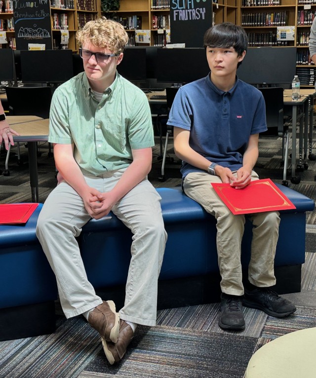 (from left) Jacob Mills and (right) Liam Fedak listen to their parents speak, after receiving letters of recognition from the Marine Corps Detachment Fort Eisenhower. (U.S. Army photo by Anne Bowman)