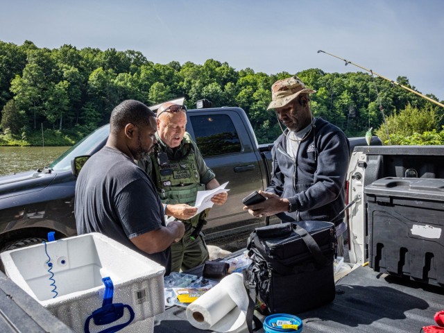 Lt. Keith Beshears, conservation law enforcement officer with the Fort Knox Directorate of Emergency Services, examines fishing permits at the installation May 31, 2024. To hunt or fish within allotted areas on post, individuals must hold valid...