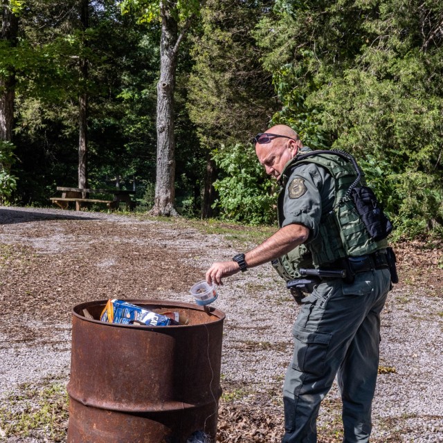Lt. Keith Beshears, conservation law enforcement officer at the Fort Knox Directorate of Emergency Services, picks up trash by Douglas Lake May 31, 2024.