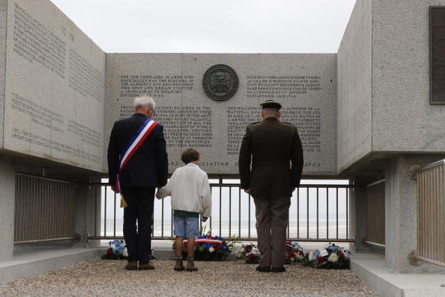 Maj. Gen. Joseph DiNonno, commanding general, 29th Infantry Division carries a wreath with Mr. Antoine de Bellaigue, mayor, Vierville-sur-Mer, France, during a remembrance ceremony at the National Guard Monument, June 2, 2024, at Dog Green Beach. DiNonno and Bellaigue offered remarks to a large crowd against the beach and a formation of 29th Infantry Division and 75th Ranger Regiment Soldiers. Soldiers assigned to Alpha and Bravo Companies, 116th Infantry Regiment and 2nd Ranger Battalion were part of the first wave of Allied forces to storm Omaha Beach, June 6, 1944. The ceremony concluded with the 29th Infantry Division Band playing the United States National Anthem, French National Anthem and Taps.