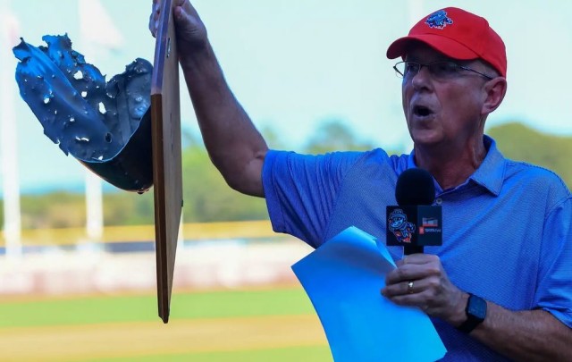 Jim Myles, head of the Huntsville/Madison County Chamber&#39;s Armed Forces Committee, showcases the Target Destroyed trophy during the 2023 Community Softball Game at Trash Pandas Stadium.