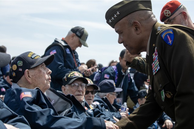 U.S. Army Gen. Darryl Williams, commanding general of U.S. Army Europe and Africa, greets WWII veteran Paul Priest, who fought in WWII with Headquarters Company, 52nd Infantry Division, 9th Armored Division, during the return of veterans for the...
