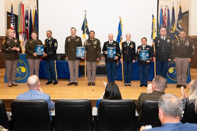 Col. W. Bochat, U.S. Army Chemical, Biological, Radiological and Nuclear School commandant (left), and USACBRNS Regimental Command Sgt. Maj. Raymond Quitugua Jr. (right) pose for a photo with representatives from the U.S. Army Chemical Corps’...