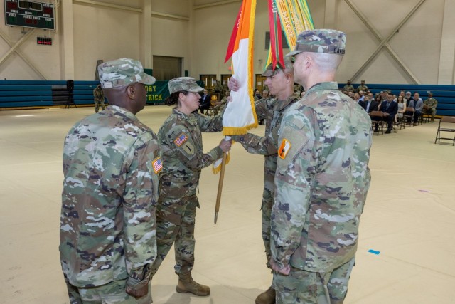 COL Julia Donley passes the colors of the 21st Signal Brigade to COL (P) Eric Van Den Bosch, Commander, 7th Signal Command (Theater), during a change of command ceremony on Ft. Detrick, 6 June 2024.