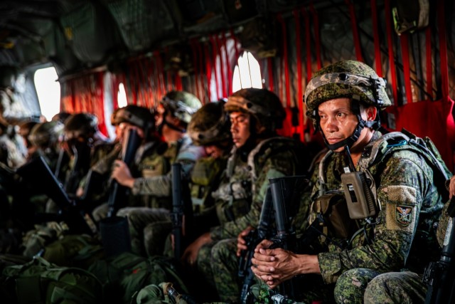 Philippines Army soldiers assigned to the 7th Infantry Division sit in a Boeing C-47 Chinook flown by the 2-25th Aviation Regiment, 25th Combat Aviation Brigade, 25th Infantry Division during an air assault maneuver as part of the Joint Pacific...