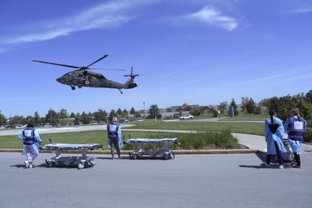 Medical staff from Aurora Medical Center-Summit’s emergency and trauma center wait for a Wisconsin Army National Guard Black Hawk helicopter to arrive so they can move notional patients to the emergency room during a mass casualty exercise May...