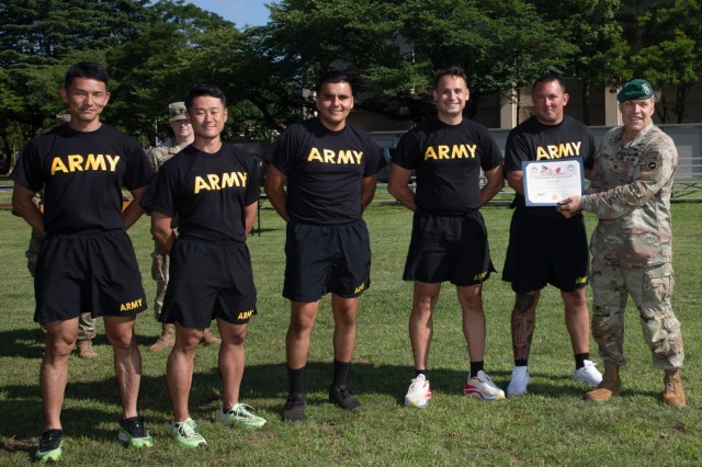 Col. Terry A. Butcher, right, deputy commander of U.S. Army Japan, presents a certificate of excellence to 38th Air Defense Artillery Brigade Soldiers who won the tug-of-war event during an Army Week awards ceremony at Camp Zama, Japan, June 12,...