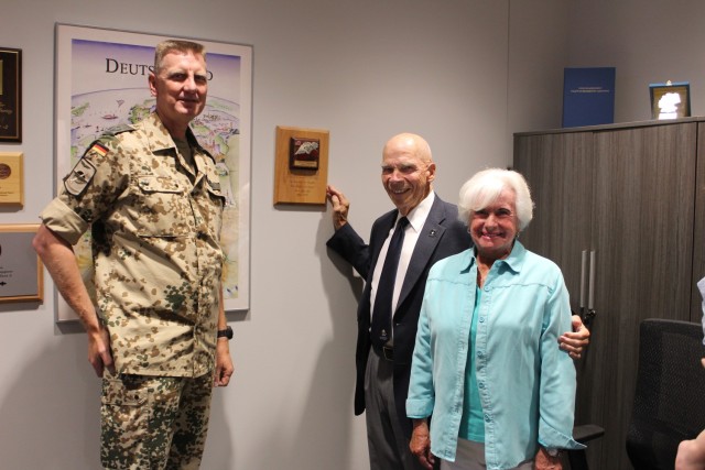 Retired Col. Jon and Pam Stieglitz present a piece of the Berlin Wall to the German Patriot Office on June 12. At left is Lt. Col. Siegfried Domabyl, director of the German Patriot Office.
