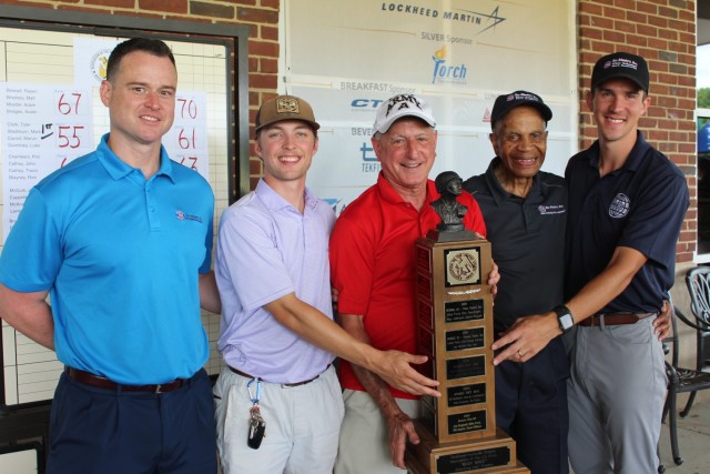 Marc Jacobson, president of Redstone-Huntsville Chapter of the Association of the U.S. Army, presents the Iron Mike trophy to the winning team from Tec-Masters Inc. From left are Mark Washburn, Tyler Clark, Jacobson, Marvin Carroll and team...