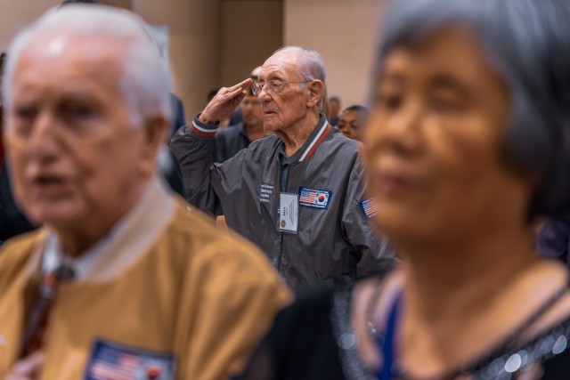 Korean War veteran Paul Reeves salutes during the “The Star-Spangled Banner” at Thursday’s 18th annual luncheon for Korean War veterans.