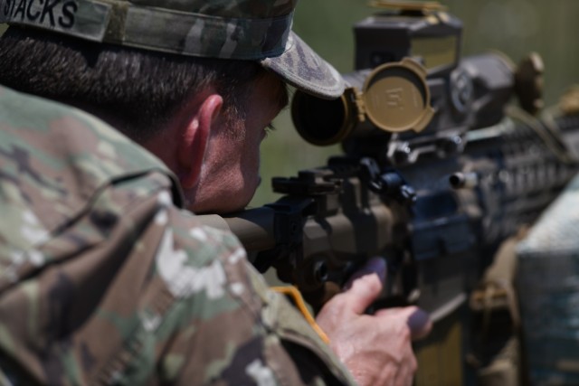 U.S. Army Sgt. 1st Class Bradley Stacks, with Headquarters and Headquarters Battery, 1st Battalion, 113th Field Artillery Regiment, North Carolina Army National Guard, engages targets with the XM7 rifle and XM157 scope during testing of the rifle...