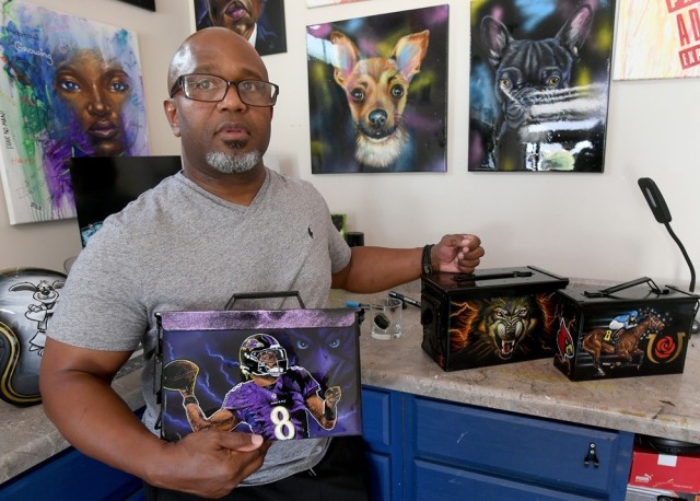 Toni Graves, a retired chief warrant officer two, uses his artistic talent to decorate ammo cans in his garage-turned-studio in Harvest.