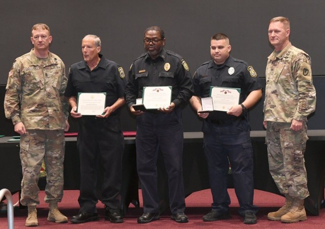 From left, Garrison Command Sgt. Maj. Dylan Lemasters, security guards Joseph Szmetko, Cornelius Johnson, Colton Caler and Garrison Commander Col. Brian Cozine take part in the Garrison’s third quarter fiscal year 2024 awards ceremony June 27 at...