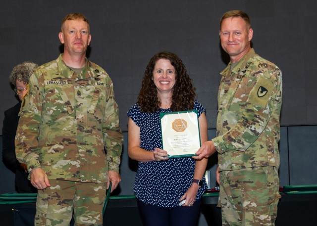 Garrison Command Sgt. Maj. Dylan Lemasters and Garrison Commander Col. Brian Cozine present Kara Malone, an IMCOM Installation Directorate-Sustainment Stalwart Award recipient, with a 15-year service award at the third-quarter fiscal year 2024...