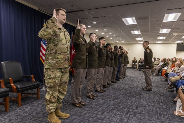 Brig. Gen. Eric J. Van Den Bosch administers the oath of enlistment to 11 Soldiers from 7th Signal Command (Theater) in a 12 July 2024 ceremony on Ft. Meade, MD.