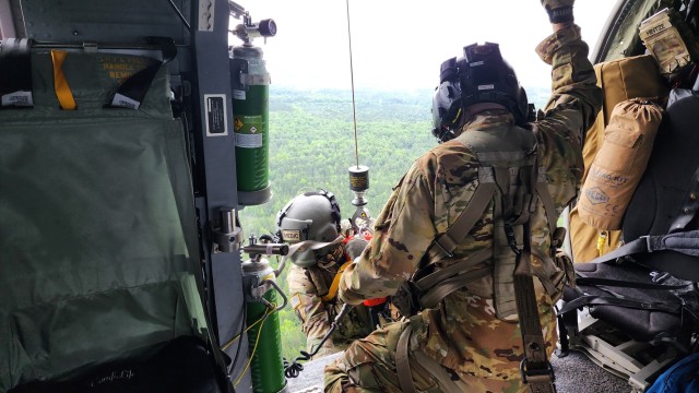 Sgt. Zachary Hintze, a crew chief assigned to a Wisconsin Army National Guard UH-60 Black Hawk crew from West Bend, Wis., hoists Sgt. 1st Class Eric Furbee, a critical care flight paramedic, back into the aircraft after a successful patient...