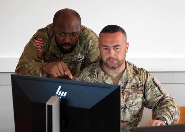 Maryland Army National Guard Sgt. Emmanuel Unaka, cyber threat intelligence analyst with Cyber Protection Team 169, listens to Armed Forces of Bosnia and Herzegovina Lt. Armin Kolašinac, a Security Operations Center member, during the Adriatic...