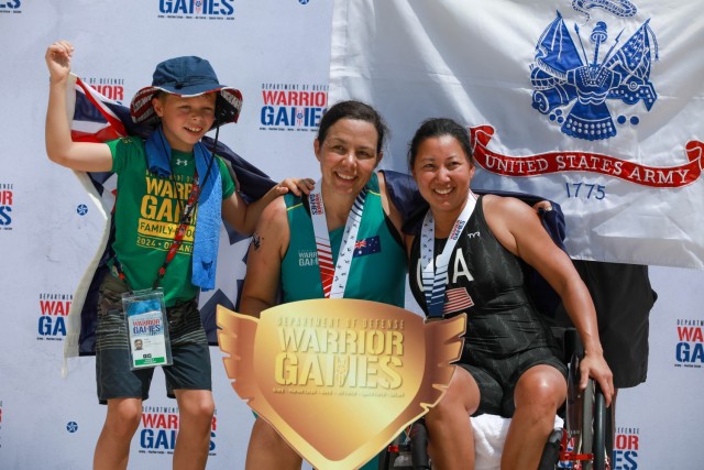 U.S. Army veteran Gabi Cha, right, poses with an athlete from Team Australian Defence Force at the swim event medal ceremony during the 2024 Department of Defense Warrior Games at the ESPN Wide World of Sports Complex in Orlando, Florida, June 29,...