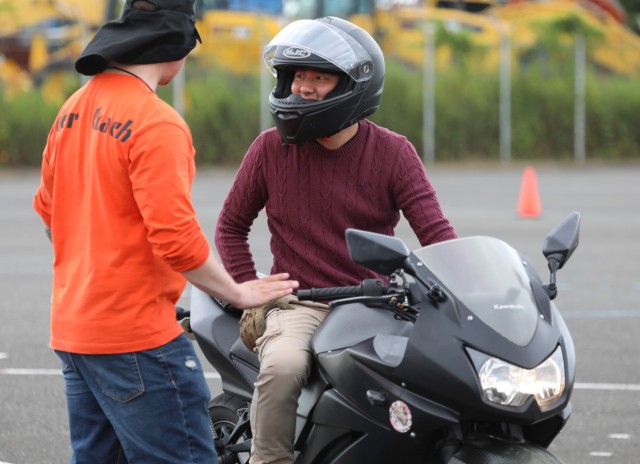 Staff Sgt. Austin Dennis, left, assigned to the 78th Signal Battalion, provides instruction to Spc. Jim Xiong, assigned to the 311th Military Intelligence Battalion, during the Basic Rider Course 1 at Yokohama North Dock, Japan, July 19, 2024....