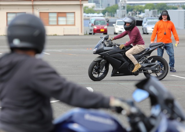 Spc. Jim Xiong, assigned to the 311th Military Intelligence Battalion, practices a maneuver during the Basic Rider Course 1 at Yokohama North Dock, Japan, July 19, 2024. U.S. Army Garrison Japan recently restarted its motorcycle safety courses...