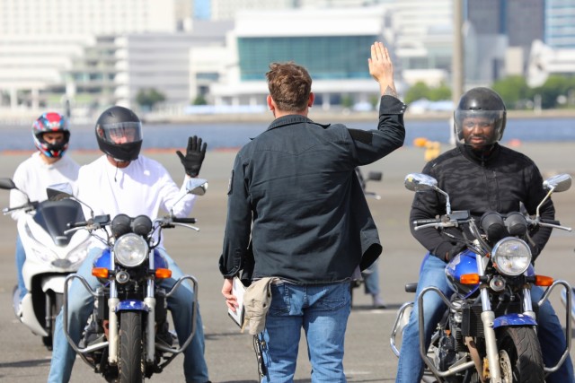 Pfc. Dylan Lepper, center, assigned to the 311th Military Intelligence Battalion, goes over hand signals while instructing students during the Basic Rider Course 1 at Yokohama North Dock, Japan, July 19, 2024. U.S. Army Garrison Japan recently...
