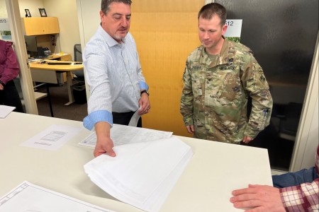 Eric Shumate, chief of engineering at the Kansas City District, U.S. Army Corps of Engineers, shows Col. Travis Rayfield, former Kansas City District commander, the final design for the Fort Leavenworth child development center project during a...