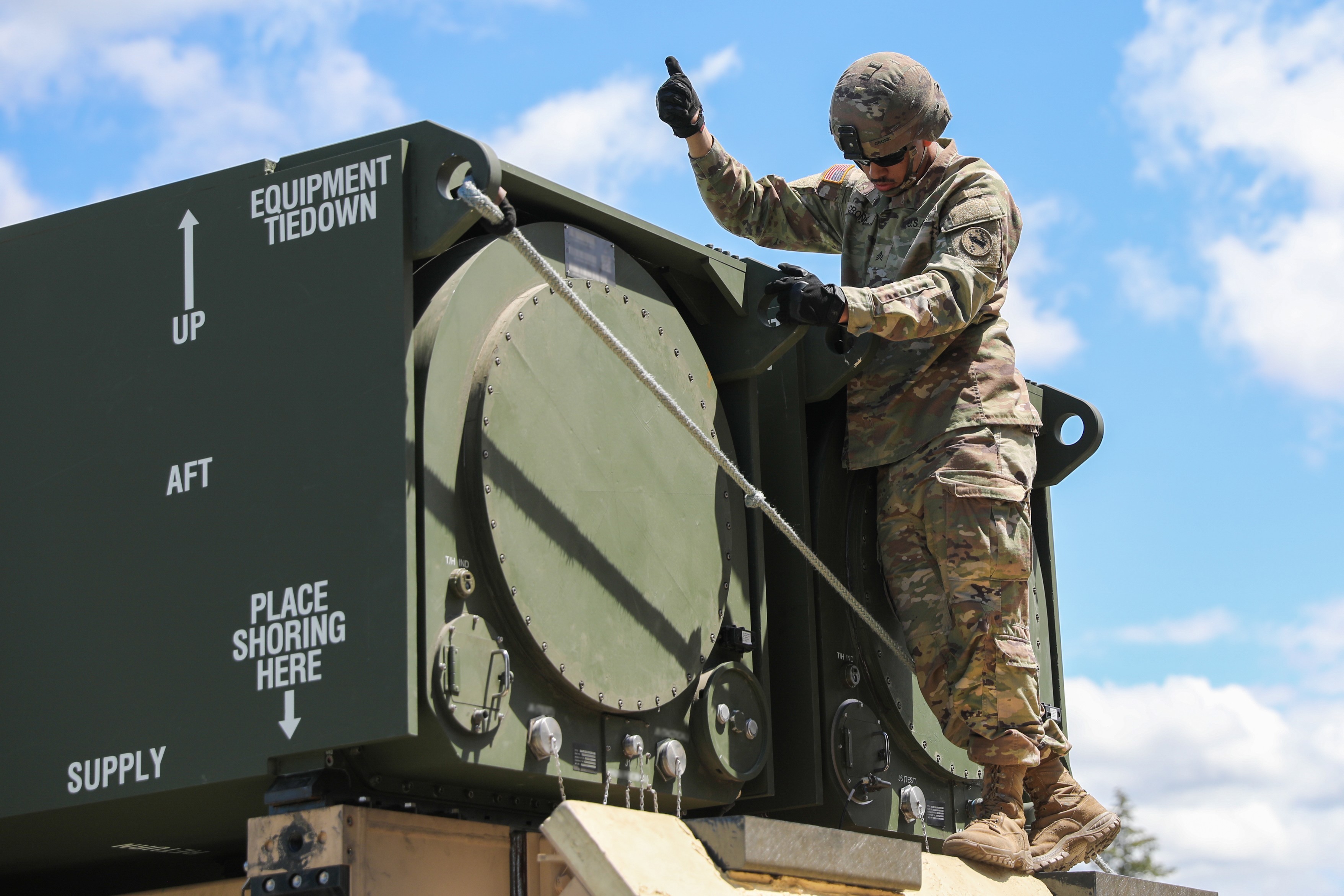 A Soldier assigned to Bravo Battery, 5th Battalion, 3rd Field Artillery (Long Range Fires Battalion), 1st Multi-Domain Task Force, confirms positive emplacement of a pod on one of the Long Range Hypersonic Weapon Transporter Erector Launchers in...