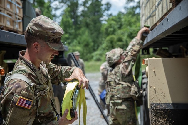 Soldiers assigned to the 53rd Brigade Support Battalion roll up straps that have used to secure ammunition during a transport from an ammunition supply point to an ammunition holding area at Camp Shelby, Mississippi, July 15, 2024. These Soldiers...