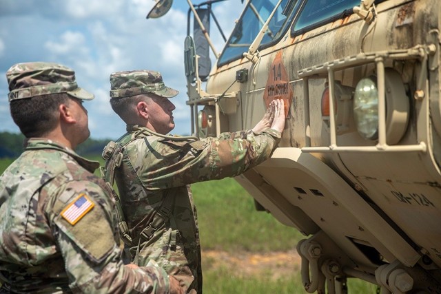 Soldiers from the 53rd Brigade Support Battalion prepare an M977A4 HEMTT cargo transporter to move ammunition from an ammunition supply point to an ammunition holding area at Camp Shelby, Mississippi, July 15, 2024. They are among almost 5,000...