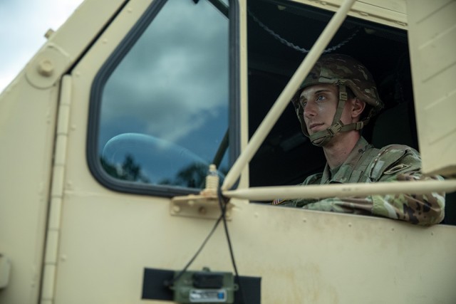 Spc. Nicholas Gneli, a motor transport operator assigned to the 53rd Brigade Support Battalion, drives a M977A4 HEMTT cargo transporter in a convoy transporting ammunition from an ammunition supply point to an ammunition holding area at Camp...