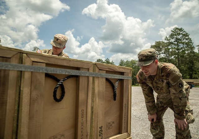 Army Sgt. Kate Bush (left) and Spc. Connor Murphy (right), ammunition specialists assigned to the 53rd Brigade Support Battalion, count and inventory ammunition that was just transported from an ammunition supply point to an ammunition holding...