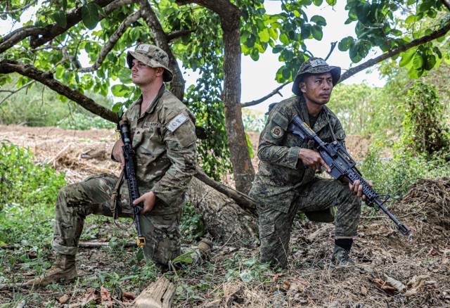 U.S. Army Sgt. Bradley Bates, assigned to Charlie Company, 2nd Battalion, 27th Infantry Regiment, 3rd Infantry Brigade Combat Team, 25th Infantry Division, provides security alongside Philippine Army Sgt. Ryel Agawayas, assigned to the 7th Philippine Army Infantry Division, for the jungle survival portion of the Jungle Operations Training Course during Exercise Balikatan 24 at Fort Magsaysay, Philippines, April 28, 2024. BK 24 is an annual exercise between the Armed Forces of the Philippines and the U.S. military designed to strengthen bilateral interoperability, capabilities, trust, and cooperation built over decades of shared experiences.