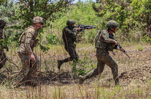 U.S. Soldiers assigned Delta Company, 2nd Battalion, 27th Infantry Regiment, 3rd Infantry Brigade Combat Team, 25th Infantry Division, observe Philippine Army soldiers, assigned to the Philippine Army 7th Infantry Division, as they rapidly engage targets during Exercise Balikatan 24 at Fort Magsaysay, Philippines, April 27, 2024. BK 24 is an annual exercise between the Armed Forces of the Philippines and the U.S. military designed to strengthen bilateral interoperability, capabilities, trust, and cooperation built over decades of shared experiences.